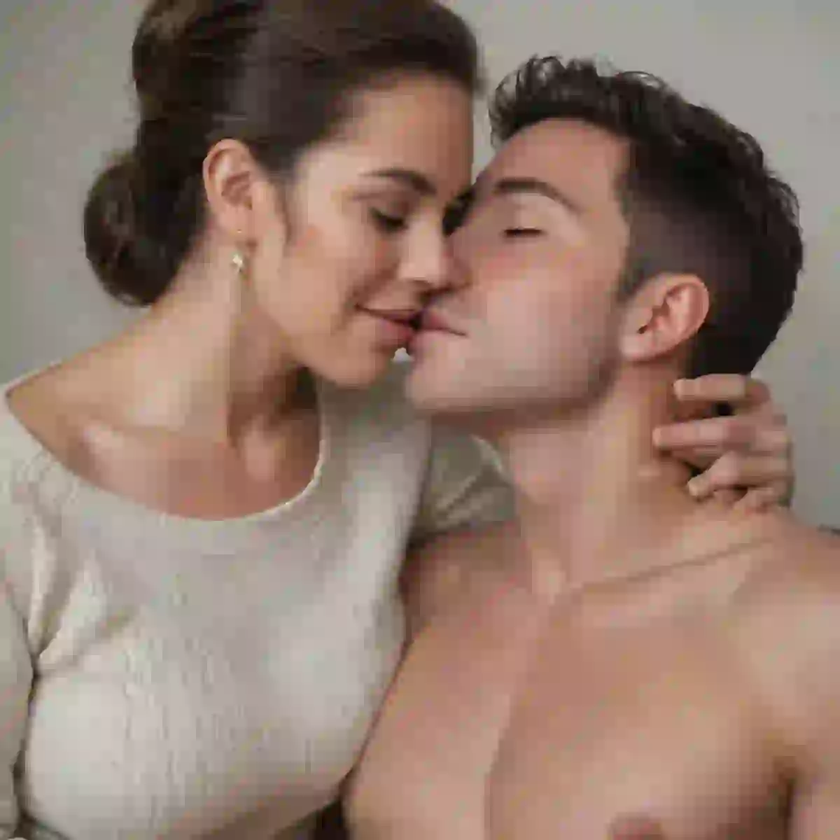 Portrait of a loving couple pecking each other's lips, the woman is in beige top and cupping the man's neck, the man is shirtless.