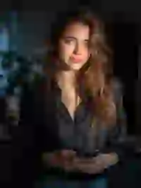 Portrait of a smiling woman in black shirt posing in an indoor scene. Template for Undress AI.